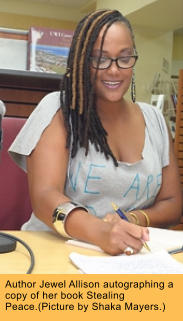 Author Jewel Allison autographing a copy of her book Stealing Peace.(Picture by Shaka Mayers.)